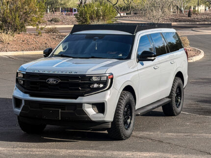 Three-quarter side angle of a Ford Expedition showcasing the full length and clearance of the Kingdom Overlanding roof rack